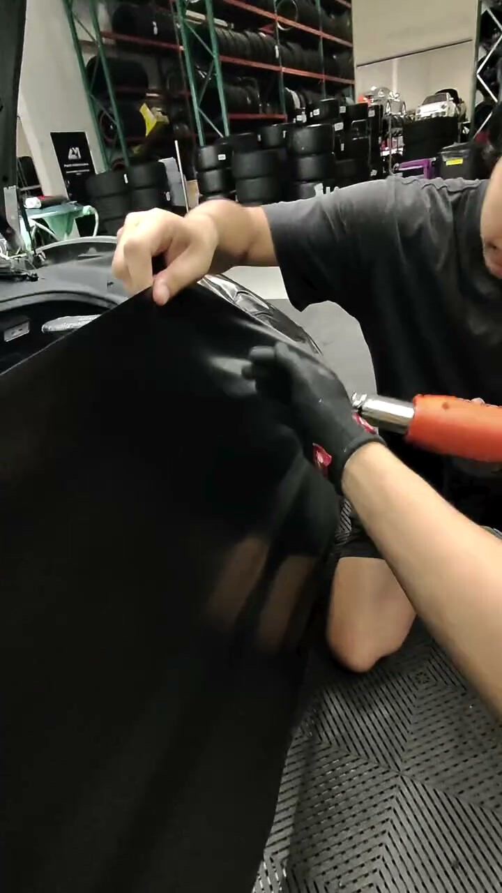 Film heated and conformed by hand over a curved panel